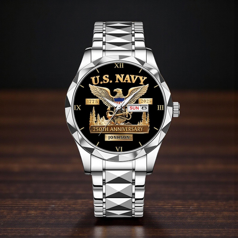 May include: A silver wristwatch with a black face featuring the text "U.S. NAVY" and an eagle emblem. The watch face also displays "1775" and "2025", with "250TH ANNIVERSARY" and the name "JONHSON" below. The watch band is silver.