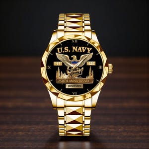 May include: A gold-toned wristwatch with a black face featuring the text "U.S. NAVY" and an eagle emblem. The watch commemorates the "250th ANNIVERSARY" and includes the years 1775 and 2025. The watch band is also gold-toned.