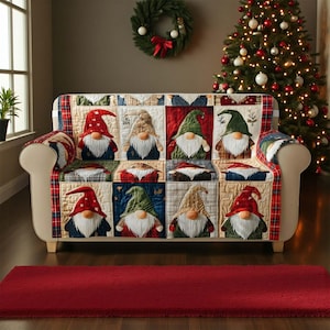May include: A sofa covered with a patchwork quilt featuring gnome designs. The gnomes have red, green, and tan hats, white beards, and are set against a backdrop of various patterns. The sofa is in a room with a Christmas tree and a red rug.