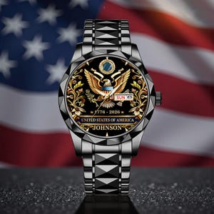 May include: A black wristwatch with a detailed face featuring a golden eagle, floral accents, and the text "UNITED STATES OF AMERICA". The watch band is silver, and the background shows the American flag.