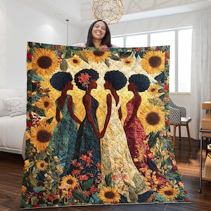Puede incluir: Un edredón colorido con cuatro mujeres con vestidos, rodeadas de girasoles y detalles florales. Las mujeres se representan de perfil, tomadas de la mano, con piel oscura y peinados naturales. El edredón tiene una combinación de colores amarillo y verde.
