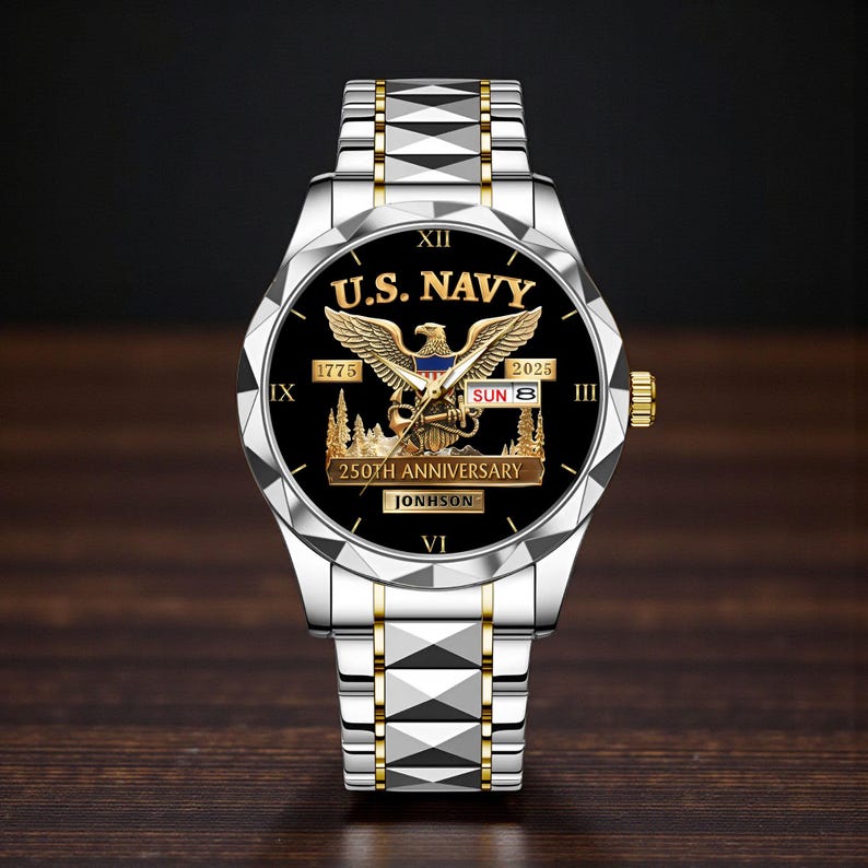 May include: A silver and gold wristwatch with a black face featuring the text "U.S. NAVY" and an eagle emblem. The watch commemorates the 250th anniversary and includes the date "SUN 8". The watch band is silver with gold accents.