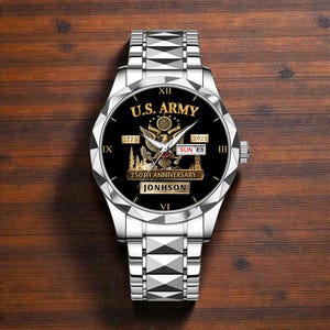 May include: Silver wristwatch with a black face featuring the text "U.S. ARMY", an eagle emblem, and the dates 1775 and 2025. The watch also displays "250TH ANNIVERSARY" and the name "JONHSON". The watchband is silver.