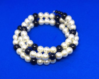 Cuff bracelet with black and ivory glass beads.