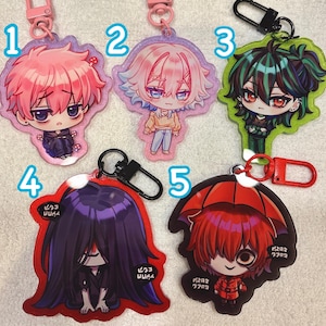 May include: A white ceramic mug with a black handle and the text "But First, Coffee" in a bold, black font. The mug is set against a blurred background, suggesting a cozy setting.