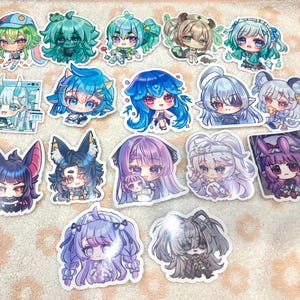 May include: A collection of fourteen die-cut vinyl stickers featuring various chibi-style anime characters with colourful hair, expressive eyes, and distinct outfits. The stickers display a range of fantasy and modern designs in vibrant shades of blue, purple, green, and pink.