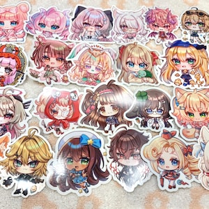 May include: A collection of twenty-one die-cut vinyl stickers featuring various anime-style chibi characters with large eyes, colorful hair, and diverse outfits, including animal-themed accessories, displayed in a grid-like arrangement.