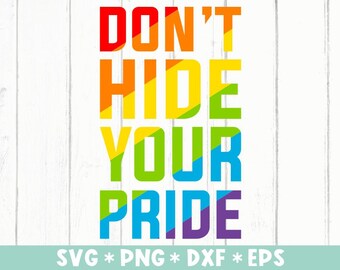 Puede incluir: Texto "Don't Hide Your Pride" en colores arcoíris sobre un fondo de madera blanca. El texto está en negrita, con una fuente de bloque. La imagen también incluye el texto SVG * PNG * DXF * EPS.