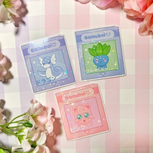 Gameboi Cart holographic vinyl stickers - dragon snake odd guy pink puff pastel video game kawaii water bottle laptop phone case pc japanese