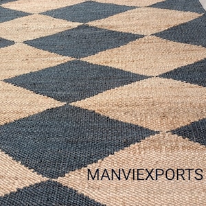 May include: A black and natural jute rug with a diamond pattern. The rug is woven with a textured, natural fiber. The rug is made by MANVIEXPORTS.