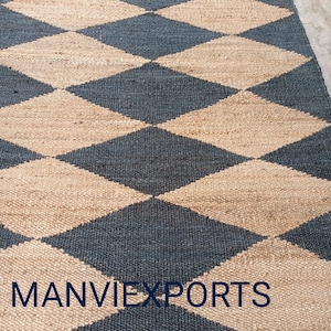 May include: A black and beige jute rug with a diamond pattern. The rug has the text "MANVIEXPORTS" woven into the bottom edge.