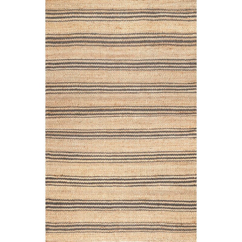 May include: A natural fiber rug with a striped pattern in beige and black. The rug is made of jute and has a woven texture.