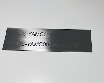 May include: A silver metal tag with the text "US-YAMCO0960431" and "US-YAMCO0960421" printed on it.