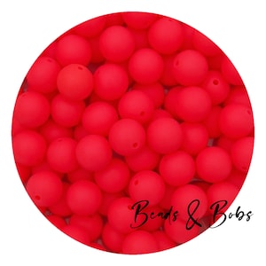 May include: A close-up image of a large quantity of bright red silicone beads. The beads are round and smooth, and they are perfect for making jewellery or other crafts.