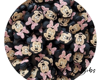 May include: A collection of black Minnie Mouse-shaped charms with tan faces, pink polka-dot bows, and black ears. These charms are ideal for crafting, jewelry making, or adding a touch of Disney magic to various projects.
