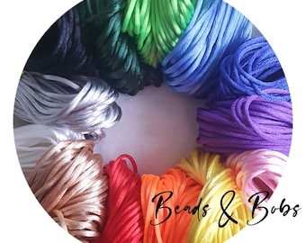 May include: A selection of waxed cotton cords in various colours, arranged in a circle. The cords are all the same thickness and are ideal for crafting.