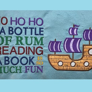 May include: A blue embroidered design with the text "Yo ho ho and a bottle of rum reading a book is so much fun" and a purple and brown ship.