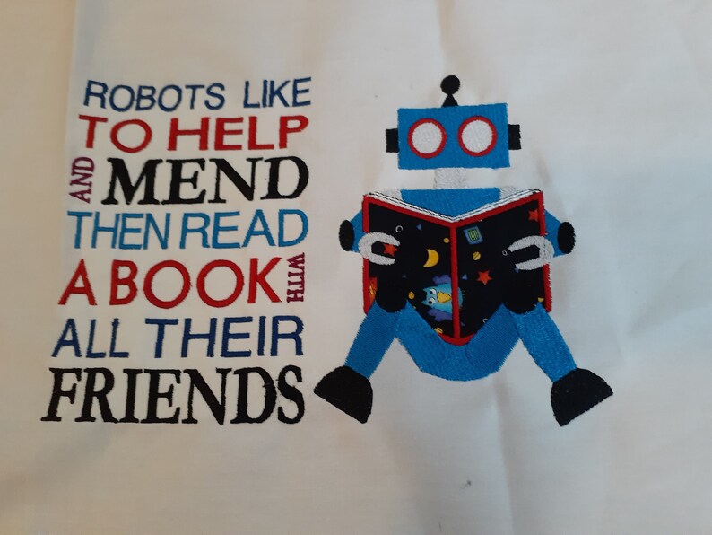 May include: A blue robot with red eyes is reading a book with stars and a moon on the cover. The text reads "Robots like to help and mend then read a book with all their friends".