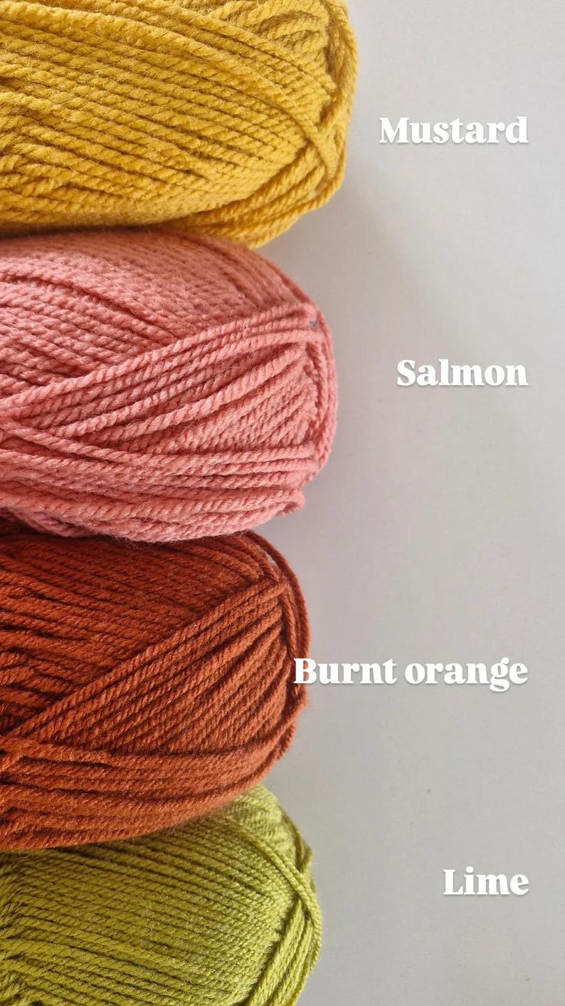 May include: Four skeins of yarn stacked vertically in mustard, salmon, burnt orange, and lime colours. Each skein is labelled with its corresponding colour name in white text to the right of the yarn. The yarn has a visible twisted fibre texture.