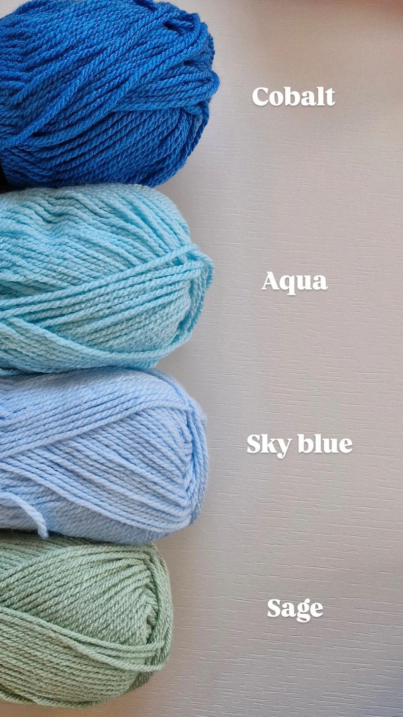 May include: Four skeins of yarn stacked vertically, labelled with text. The top skein is cobalt blue, followed by aqua, sky blue, and sage green. Each yarn ball is clearly identified by the printed text Cobalt, Aqua, Sky blue, and Sage.