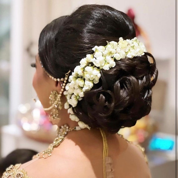 Low bun with jasmine flowers | Jasmine hair, Flowers in hair, Mother of the  groom