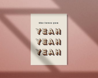 May include: A white card with the text "She loves you" and the word "YEAH" repeated three times in a retro, 3D style font. The letters are in shades of brown, orange, and yellow.
