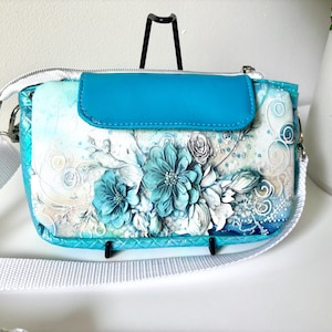 ladies clutch wallet with zipper compartment, card slots, pockets cross body strap, elegant blue floral design