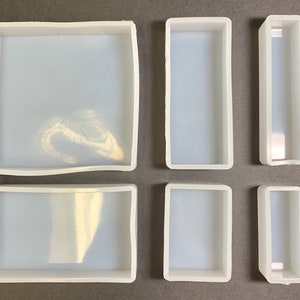 May include: Six clear silicone molds of different sizes and shapes. The molds are designed for making resin crafts.