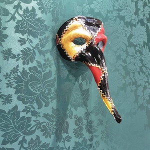 Scaramouche nose mask from the Commedia Dell Arte in papier-mâché hand painted with baroque decorations in silver leaf