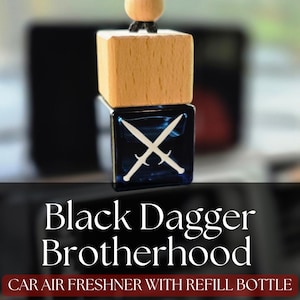 May include: Car air freshener with the text "Black Dagger Brotherhood." The air freshener has a wooden top and a dark blue square base with crossed swords. Includes a refill bottle.