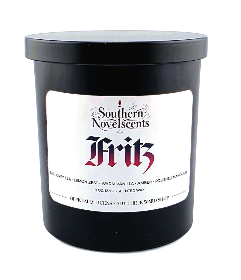 May include: A black scented candle with a white label featuring the text "Southern Novelscents Fritz." The label lists scent notes including Earl Grey Tea, Lemon Zest, and Amber. The candle contains 8 oz (226g) of scented wax.