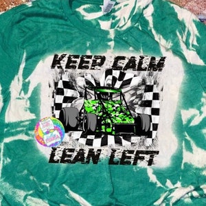 May include: Green and white tie-dye t-shirt with the text "Keep Calm Lean Left" and a green and black race car graphic.
