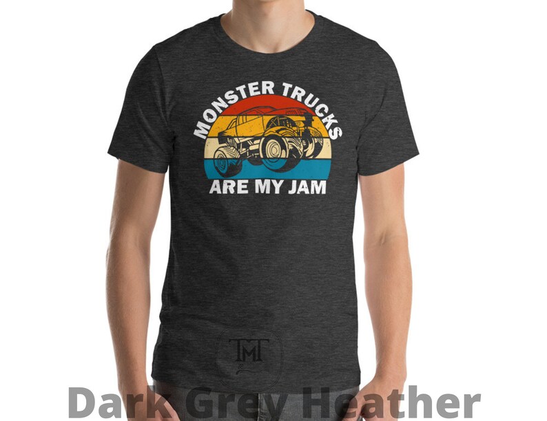 May include: Dark grey heather t-shirt with a vintage-style graphic of a monster truck. The graphic says "Monster Trucks Are My Jam".