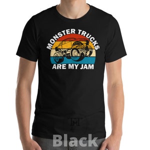 May include: Black t-shirt with a vintage-style graphic of a monster truck. The graphic features a red, orange, yellow, and blue color scheme and the text "Monster Trucks Are My Jam".