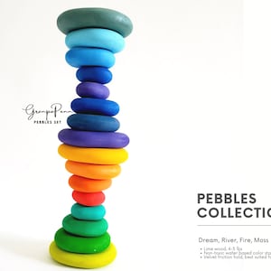 May include: A tower of colorful, painted wooden pebbles in shades of green, blue, purple, orange, and yellow. The pebbles are stacked on top of each other. The text "Grampa Penn PEBBLES SET" is in the upper left corner. The text "PEBBLES COLLECTION" is on the right.
