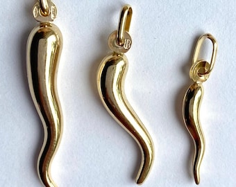 May include: Three gold-colored pendants shaped like a horn of plenty, in three different sizes: large, medium, and small.