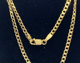 May include: A gold chain necklace with a curb link style. The chain is on a black background.
