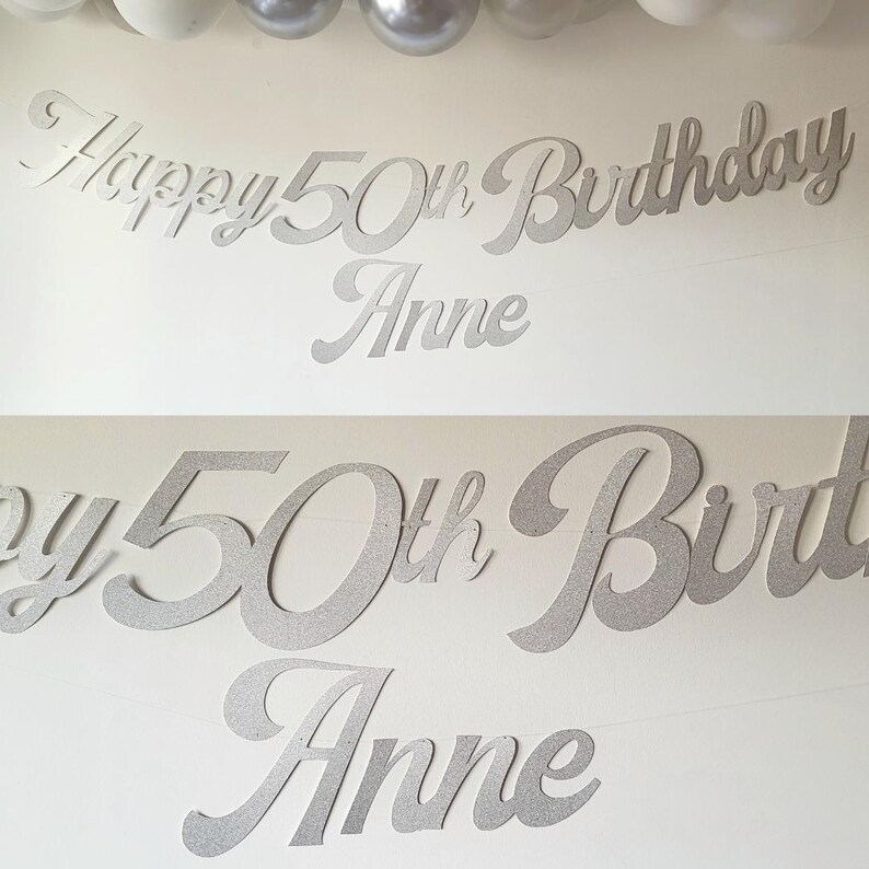 May include: Silver glitter Happy 50th Birthday banner with the name Anne. The banner is made of cardstock and is perfect for a 50th birthday party.