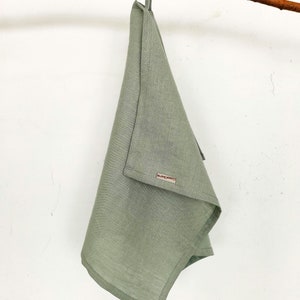 Sage green kitchen towel. Our linen towels have a loop, so you can hang it in any convenient place. Our logo gives the towel an even more expensive look. Linen towels a stylish addition to any kitchen.