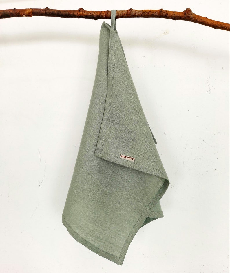 Sage green kitchen towel. Our linen towels have a loop, so you can hang it in any convenient place. Our logo gives the towel an even more expensive look. Linen towels a stylish addition to any kitchen.