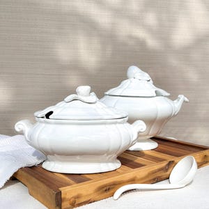 May include: A trio of ceramic mugs with a speckled, matte finish in cream, light grey, and dark grey. Each mug features a simple, minimalist design, ideal for tea or coffee.