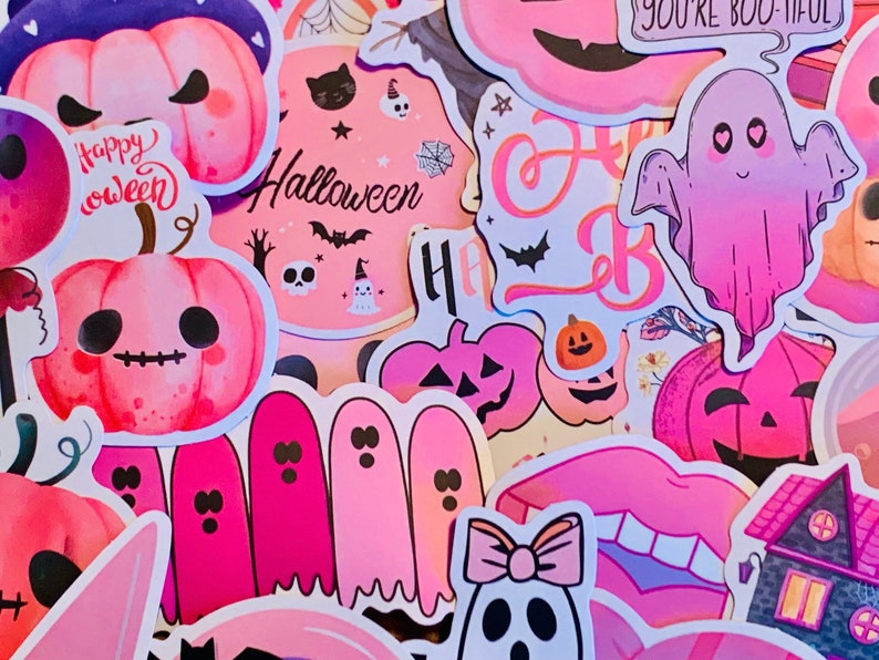 May include: A collection of pink and purple Halloween stickers featuring ghosts, pumpkins, and the words "Happy Halloween".