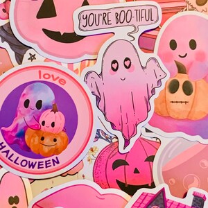 May include: A collection of pink and purple Halloween themed stickers featuring ghosts, pumpkins, a house, and the text "You're Boo-tiful" and "Love Halloween".