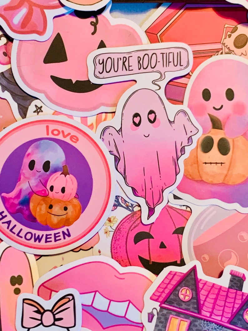 May include: A collection of pink and purple Halloween themed stickers featuring ghosts, pumpkins, a house, and the text "You're Boo-tiful" and "Love Halloween".