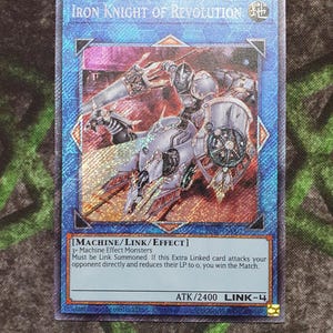 May include: A blue and silver card with a robot illustration. The card is titled "Iron Knight of Revolution" and has the text "[MACHINE/LINK/EFFECT] 3 - Machine Effect Monsters Must be Link Summoned. If this Extra Linked card attacks your opponent directly and reduces their LP to 0, you win the Match. ATK/2400 LINK-4".