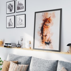 May include: A watercolor painting of a ginger cat with green eyes, sitting on a white background. The painting is framed in a black frame and hanging on a white wall. The cat is wearing a collar with a tag.
