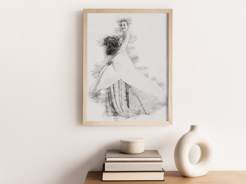 May include: A framed black and white pencil sketch of a woman in a wedding dress holding a bouquet of flowers.