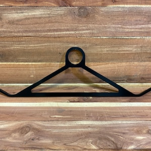 May include: Black metal hanger with a triangular shape and a round hole at the top.