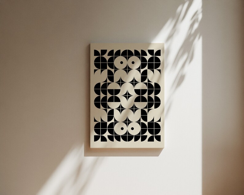 May include: A black and white geometric pattern print on a cream background. The pattern is made up of circles, half circles, and squares.