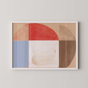 Puede incluir: Impresión artística abstracta en un marco blanco. La obra presenta un diseño geométrico con un semicírculo rojo, un cuadrado blanco, un rectángulo azul y un semicírculo marrón. El fondo es de color beige claro.